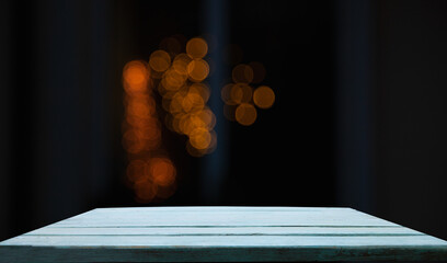 empty table on dark background with blurred lamps, cafe restaurant bokeh for your product or customization