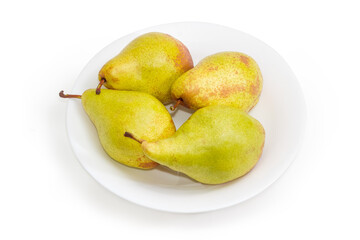 Yellow-green pears on dish on a white background