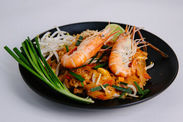 Udon Pad Thai Shrimp Black Plate White background Asian food