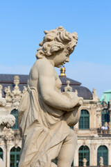 Fototapeta na wymiar 18th century baroque Zwinger Palace, sculpture at the top of Long gallery, Dresden, Germany