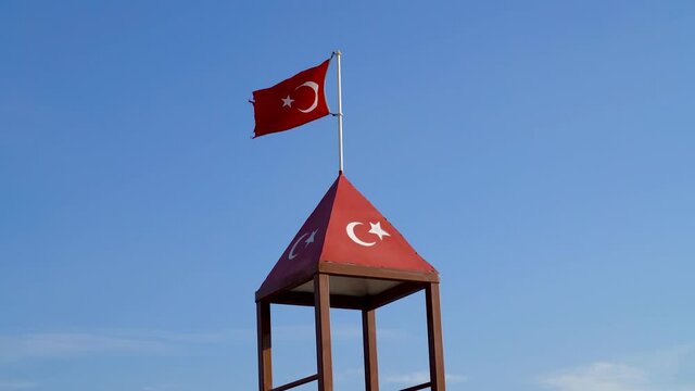 Turkish flag waving at blue sky. Turkey country flag flowing in the wind at blue sky.