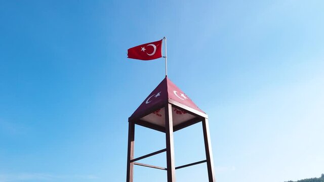 Turkish flag waving at blue sky. Turkey country flag flowing in the wind at blue sky.
