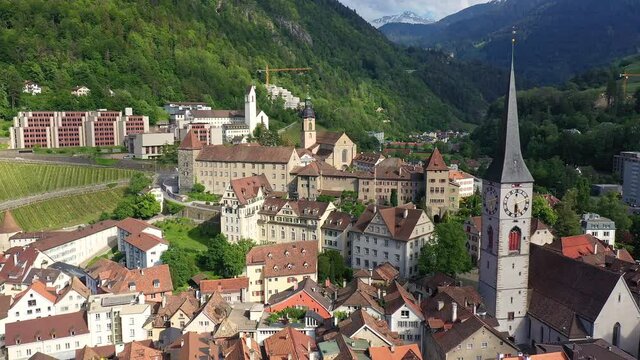 Aerial drone footage of the Chur old town, the capital city of Canton Graubunden in eastern Switzerland in summer. Shot with a forward motion. 