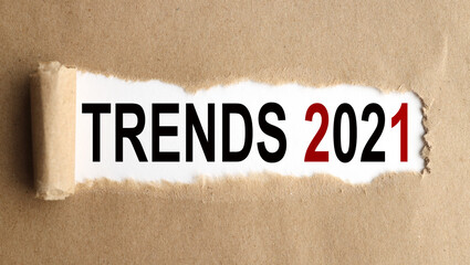 TRENDS 2021. text on white paper on torn paper background