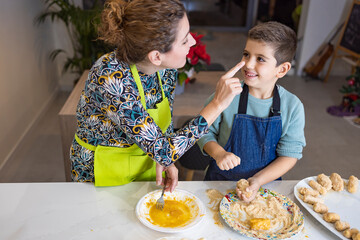 Mother and son making croquettes in the kitchen