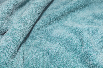Fototapeta na wymiar Texture of a turquoise towel fabric background
