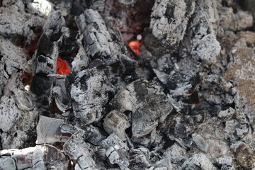 Ash embers close-up black and white grey with red weekend barbecue holiday background