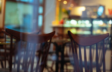 Abstract cafe reality game with chairs and pedestrians reflections in a glass showcase on a street of Riga