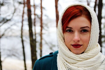 beautiful girl walking in the forest in winter