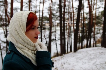 beautiful girl walking in the forest in winter