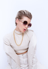 Fashion Girl with short hair. Stylish Details of everyday look. Casual beige outfit and...
