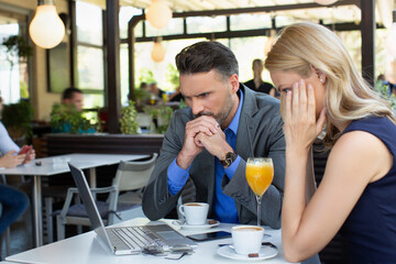 Worried business woman on a meeting in the restaurant, bad news concept