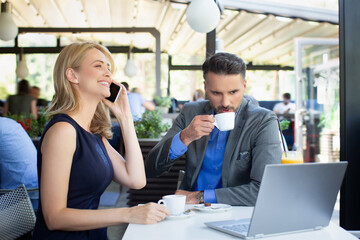 Handsome couple having business meeting in the cafe restaurant