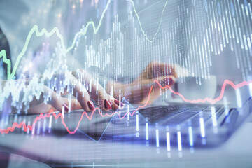 Multi exposure of woman hands typing on computer and financial graph hologram drawing. Stock market analysis concept.