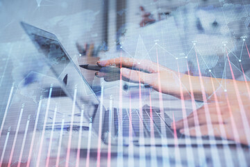 Multi exposure of woman hands typing on computer and financial graph hologram drawing. Stock market analysis concept.