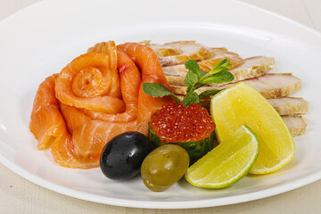 Sliced fish snack with salmon, caviar and strugeon