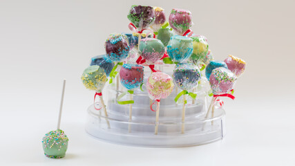 Colorful cake pops on white background