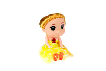 A doll in a yellow dress. On a white background, isolated.