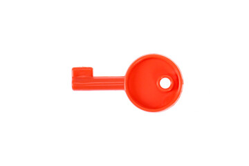 red plastic toy key. On a white background, isolated.