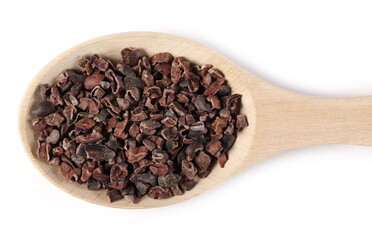 Chopped, grated cocoa pieces in wooden spoon isolated on white background, top view