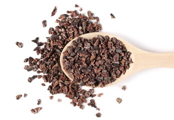 Chopped, grated cocoa pieces in wooden spoon isolated on white background, top view