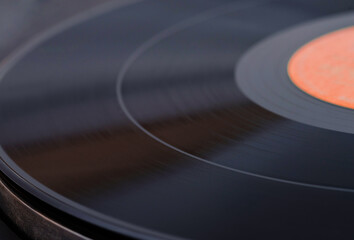 Black vinyl plate with soundtracks on it, selective focus, close-up..