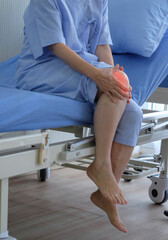 Patient sit on sit on the hospital bed in hospital hold knee. Knee inflammation