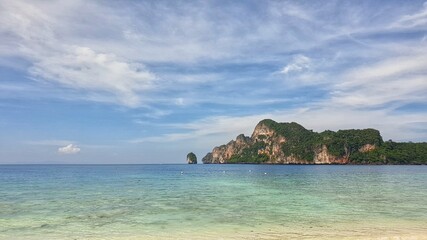Fototapeta na wymiar panoramic view of beautiful turquoise sea water with blue sky at Monkey Bay where is one of famous beach in Krabi Island, Thailand