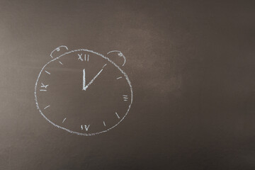 The alarm clock is drawn in chalk on a black background.