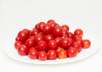 Cherry tomatoes in a plate on a white background