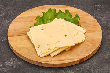 Sliced yellow cheese over board