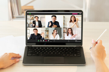 Online conference. Business webinar. Virtual presentation. Digital meeting. Successful diverse multiracial team working from home on project on laptop screen at light modern workplace.