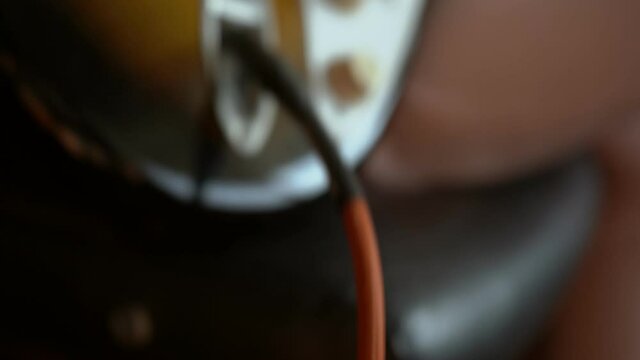 A woman playing electric guitar