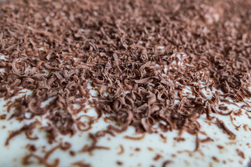 chopped dark chocolate on a cake close-up