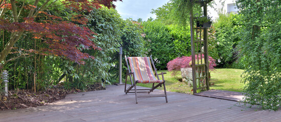 deck chair on a wooden terrace and garden