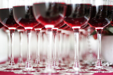 close view on many red wine glasses. Luxury table for a Banquet. Table set for a party