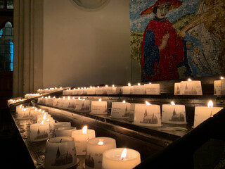 Rows of glowing candles in Marienkirche -  Church of Saint Mary near Alexanderplatz in Berlin,...