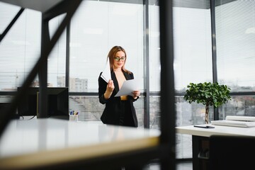 Fototapeta premium Portrait of smiling modern business woman in office