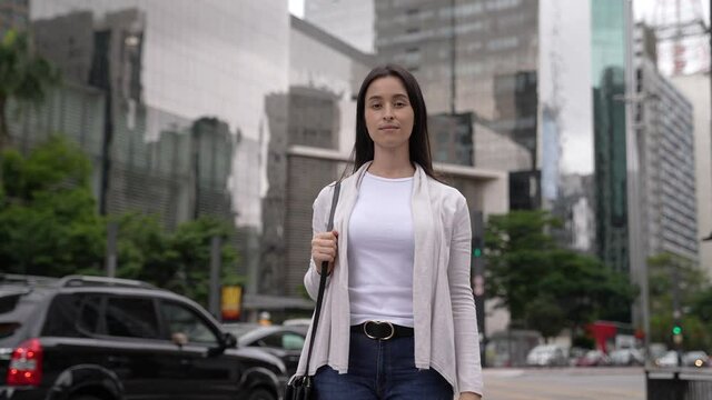 One pretty young white woman walking in the city street at paulista avenue in sao paulo brazil in slow motion
