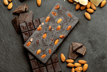 
Chocolate and cocoa concept. Cocoa butter and broken chocolate on black background, top view, copy space