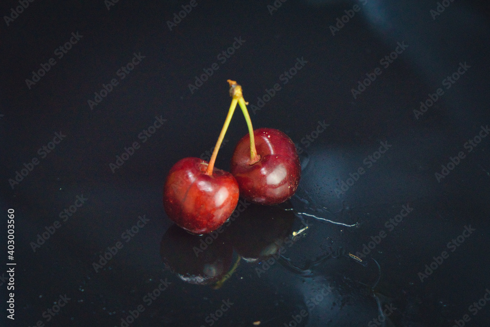 Wall mural cherries on a black background