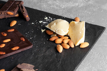 
pieces of cocoa butter, close up isolated on black stone background, composition