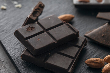 
Handmade raw vegan chocolate with almonds on dark graphite background