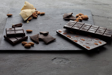 
Handmade raw vegan chocolate with almonds on dark graphite background