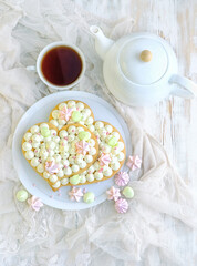 sponge cake, teapot and teacup on table. romantic sweets tea party. Valentine's day, 14 february holiday concept. flat lay