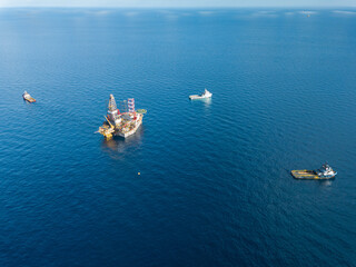 Offshore drilling rig (jack up rig) and tow vessels during the rig move operation in the middle of...