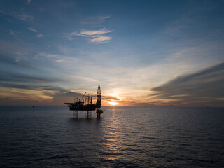 Aerial view offshore drilling rig (jack up rig) at the offshore location during sunset