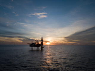 Fototapeta na wymiar Aerial view offshore drilling rig (jack up rig) at the offshore location during sunset