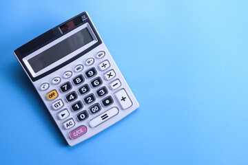 Calculator keypad on a blue background. Top view. Copy space