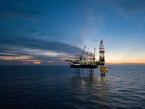 Aerial view offshore drilling rig (jack up rig) at the offshore location during sunset